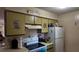 Efficient kitchen layout with white appliances and tile flooring providing space for everyday cooking needs at 1240 Sago Palm Blvd # 1240, Kissimmee, FL 34741