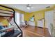 This bright bedroom includes a bunkbed, ceiling fan, hardwood floors, and window with curtains at 1437 Swift Ct, Kissimmee, FL 34759