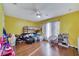 Bedroom with yellow walls, hardwood floors, bunk beds, and a ceiling fan at 1437 Swift Ct, Kissimmee, FL 34759