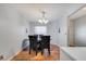 Formal dining room with wood floors, decorative lighting, and dark upholstered chairs at 1437 Swift Ct, Kissimmee, FL 34759