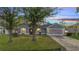 Charming home with a well-maintained lawn, complemented by mature trees and a two car garage at 1437 Swift Ct, Kissimmee, FL 34759
