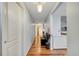 Hallway with wood floors, white walls, and a doorway leading to another room at 1437 Swift Ct, Kissimmee, FL 34759