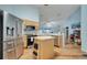 Open kitchen featuring stainless steel appliances, breakfast bar, and laminate wood flooring at 1437 Swift Ct, Kissimmee, FL 34759