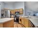 Bright kitchen featuring stainless steel appliances, light wood cabinets, and an open layout at 1437 Swift Ct, Kissimmee, FL 34759