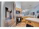 Well-lit kitchen featuring stainless steel appliances, wooden cabinets, and a view into an adjacent room at 1437 Swift Ct, Kissimmee, FL 34759