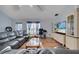 Bright living room boasts wood laminate flooring, a ceiling fan and entertainment center at 1437 Swift Ct, Kissimmee, FL 34759