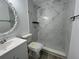 Modern bathroom featuring marble-style tiling, a rainfall shower head, and sleek fixtures at 1749 Sorolla Ct, Orlando, FL 32811