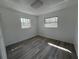 A bright bedroom is naturally lit by two windows and showcases modern flooring at 1749 Sorolla Ct, Orlando, FL 32811