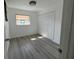 Bedroom featuring updated flooring, a window with bars, and closet with paneled doors at 1749 Sorolla Ct, Orlando, FL 32811