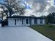 Beautifully remodeled white brick home with nice curb appeal and refreshed driveway at 1749 Sorolla Ct, Orlando, FL 32811