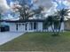Charming white brick home with well-manicured lawn and quaint landscaping at 1749 Sorolla Ct, Orlando, FL 32811