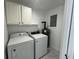 Well-lit laundry room featuring modern washer and dryer units at 1749 Sorolla Ct, Orlando, FL 32811