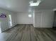 Open-concept living room featuring modern flooring and freshly painted white walls at 1749 Sorolla Ct, Orlando, FL 32811