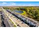 Overhead view of townhomes near a scenic pond, showcasing the community's desirable location at 2569 Reading Trl, Kissimmee, FL 34746