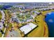 An aerial perspective of a community pool, park, and amenity center by a lake at 2569 Reading Trl, Kissimmee, FL 34746