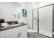 Clean bathroom with a glass-enclosed shower, modern vanity, and neutral color palette at 2569 Reading Trl, Kissimmee, FL 34746