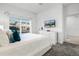 Comfortable bedroom featuring a plush bed, dresser with TV and bright natural light from the window at 2569 Reading Trl, Kissimmee, FL 34746