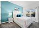 Stylishly decorated bedroom with a plush bed, accent wall, and bright natural light from the window at 2569 Reading Trl, Kissimmee, FL 34746