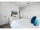 Well-lit bedroom featuring a plush bed, dresser with TV and bright natural light from the windows at 2569 Reading Trl, Kissimmee, FL 34746