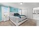 Bright bedroom with queen bed, accent wall, white furniture, and ensuite bathroom at 2569 Reading Trl, Kissimmee, FL 34746