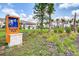 Fireside Park sign with view of lawn, homes, and landscaping at 2569 Reading Trl, Kissimmee, FL 34746
