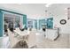 Bright dining area open to the living room with modern lighting, stylish furnishings, and a view of the screened patio at 2569 Reading Trl, Kissimmee, FL 34746