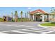 The Cove at Storey Lake entrance featuring a gatehouse and palm trees at 2569 Reading Trl, Kissimmee, FL 34746