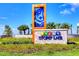 Beautiful entryway sign to Storey Lake community with tropical design and well maintained landscaping at 2569 Reading Trl, Kissimmee, FL 34746