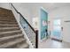 Inviting entryway with staircase, modern decor, tiled floor, and a stylish console table near the front door at 2569 Reading Trl, Kissimmee, FL 34746