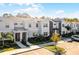 Street view showcasing modern townhome exteriors with well-kept lawns, fresh landscaping, and ample parking at 2569 Reading Trl, Kissimmee, FL 34746
