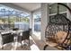 Relaxing screened-in patio with wicker furniture and swing seat overlooking the pool at 2569 Reading Trl, Kissimmee, FL 34746