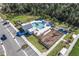 Aerial view of community pool with lounging area, playground, and parking at 2569 Reading Trl, Kissimmee, FL 34746