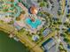 An aerial view shows the shape of the pool complex, including a splash pool, spa, and covered eating area at 2569 Reading Trl, Kissimmee, FL 34746