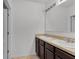 This spacious bathroom features dual sinks, a large mirror, and brown cabinetry at 260 Willow Bend Dr, Davenport, FL 33897