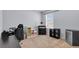 Bright, neutral bedroom features a desk, storage shelving, mini-fridge, and large window at 260 Willow Bend Dr, Davenport, FL 33897