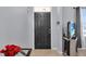 Modern interior view of the black front door with tile flooring and gray walls at 260 Willow Bend Dr, Davenport, FL 33897