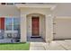 Inviting front porch with seating area and an arched entryway to the front door at 260 Willow Bend Dr, Davenport, FL 33897