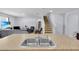 Open concept: Kitchen with island sink that overlooks a living room and stairway at 260 Willow Bend Dr, Davenport, FL 33897