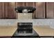 Close-up of the kitchen area featuring a black stovetop and light countertops at 260 Willow Bend Dr, Davenport, FL 33897