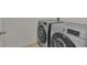 Modern laundry room featuring front load washer and dryer with decorative accents on the machines at 260 Willow Bend Dr, Davenport, FL 33897