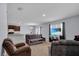 The open-plan living room features comfortable seating, a kitchen view, and a large TV at 260 Willow Bend Dr, Davenport, FL 33897