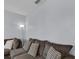 Inviting living room features a plush grey sectional sofa with geometric print throw pillows and warm lighting at 260 Willow Bend Dr, Davenport, FL 33897