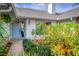 Inviting entrance features a charming light blue front door and lush, mature landscaping at 2718 Nakina Ct, Orlando, FL 32837