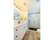 Bathroom with white vanity, modern faucet, and glass shower with black hardware at 2931 Chilton St, Deltona, FL 32738