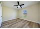 Bright bedroom with a ceiling fan, wood-look floors, and natural light from a window at 2931 Chilton St, Deltona, FL 32738