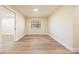 Sun-filled bedroom featuring wood-look flooring, a large window with natural light, and a spacious closet at 2931 Chilton St, Deltona, FL 32738