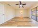 Spacious bedroom with wood-look floors, ceiling fan, and a sliding glass door at 2931 Chilton St, Deltona, FL 32738