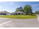 Landscaped front yard of a charming single-story home with fresh exterior paint, black trim, and driveway on a sunny day at 2931 Chilton St, Deltona, FL 32738