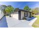 Well-maintained home with neutral paint, black accents, gray driveway, and a yard decorated with river rock and green plants at 2931 Chilton St, Deltona, FL 32738