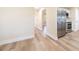 Hallway view of stainless steel refrigerator and connecting rooms at 2931 Chilton St, Deltona, FL 32738